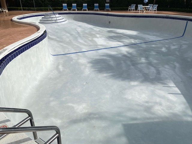 Community pool with a newly remodeled interior finish and waterline tile